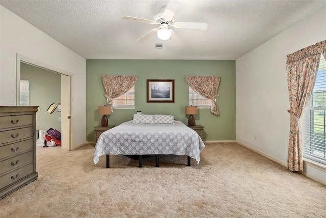 9011 Tavenor Ln, Houston, TX 77075 - bedroom featuring light colored carpet, a textured ceiling, ceiling fan, and baseboards