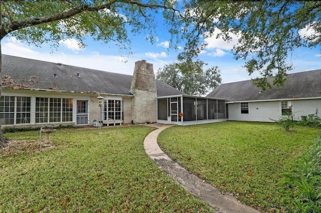 9011 Tavenor Ln, Houston, TX 77075 - back of property featuring a sunroom, a lawn, and a chimney