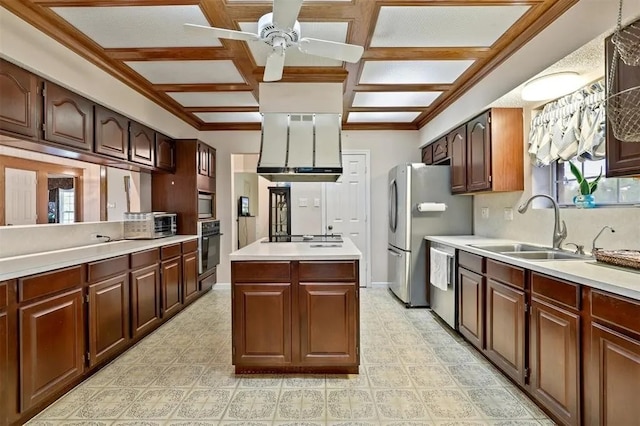 kitchen with ceiling fan, a sink, black appliances, coffered ceiling, and wall chimney exhaust hood