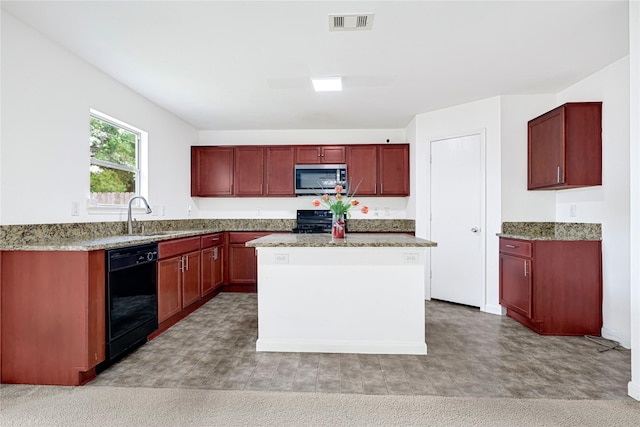 kitchen featuring a kitchen island, visible vents, a sink, black appliances, and reddish brown cabinets