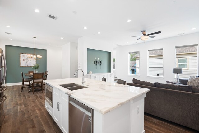 kitchen featuring a sink, stainless steel appliances, open floor plan, white cabinetry, and visible vents