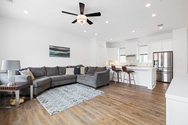 living room with recessed lighting, ceiling fan, visible vents, and wood finished floors