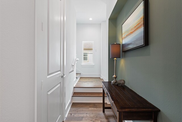 corridor with recessed lighting, baseboards, and wood finished floors