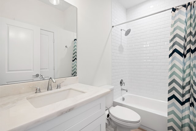 bathroom featuring vanity, shower / tub combo with curtain, and toilet