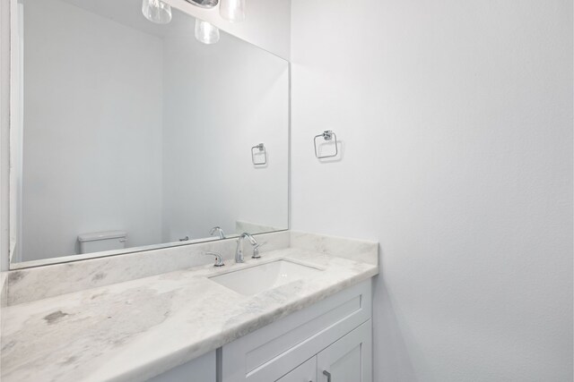 half bathroom with toilet and vanity