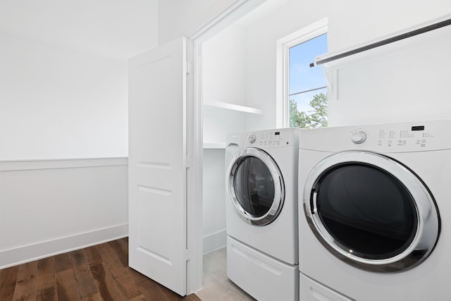 laundry room featuring separate washer and dryer, baseboards, laundry area, and dark wood-style floors