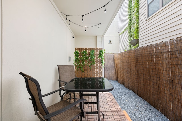 view of patio with outdoor dining area and fence