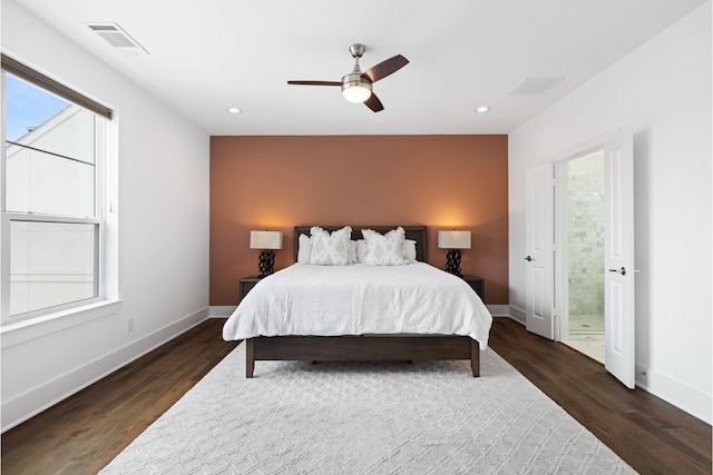 bedroom with baseboards, visible vents, and dark wood-style floors