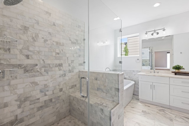 bathroom with vanity, recessed lighting, a freestanding tub, and a stall shower