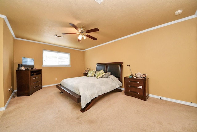 bedroom featuring a ceiling fan, visible vents, baseboards, ornamental molding, and light carpet