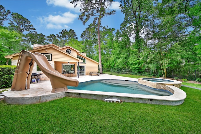view of pool with a yard, a patio, a water slide, and fence