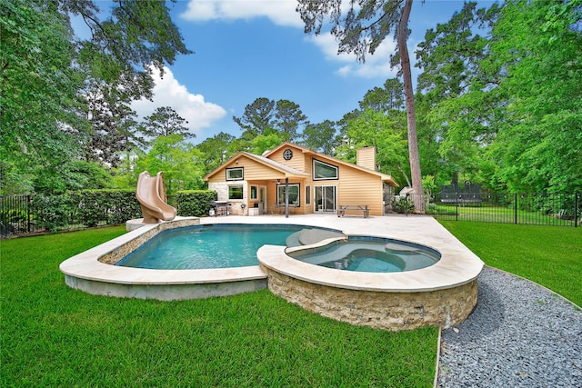 view of swimming pool featuring a yard, a water slide, a fenced backyard, and a patio area