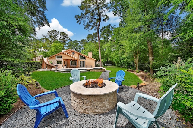 view of yard with a patio and an outdoor fire pit