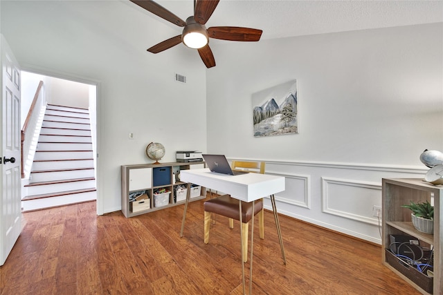 office area featuring ceiling fan, vaulted ceiling, wood finished floors, and visible vents
