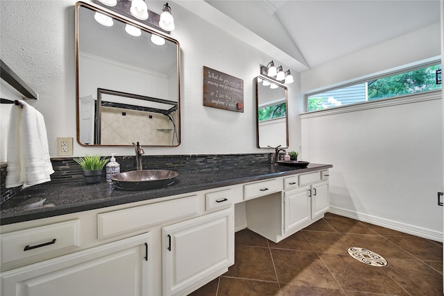 full bathroom featuring a sink, tile patterned flooring, double vanity, and lofted ceiling