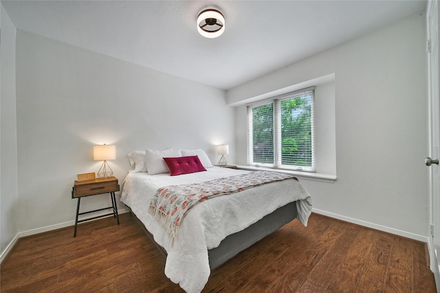 bedroom featuring baseboards and wood finished floors