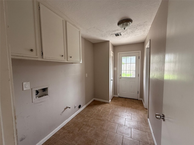 laundry room with a textured ceiling, hookup for a gas dryer, cabinet space, baseboards, and hookup for a washing machine
