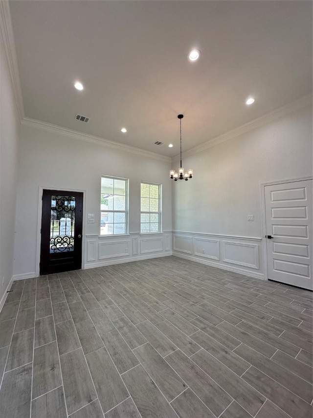 507 Kickapoo Dr, Anahuac, TX 77514 - interior space with crown molding, a decorative wall, and a chandelier