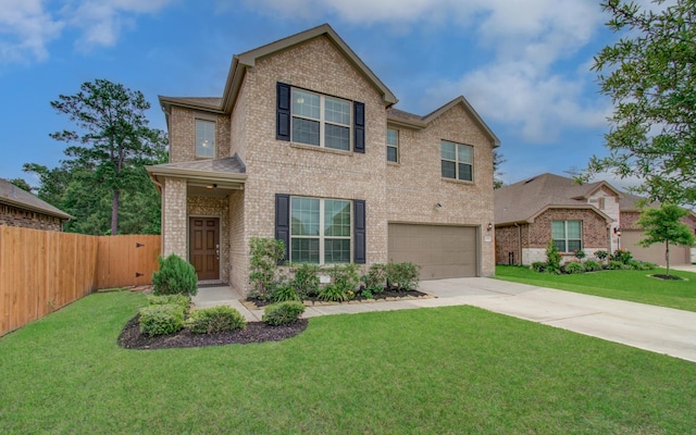 traditional-style home with a garage, fence, a front yard, brick siding, and concrete driveway