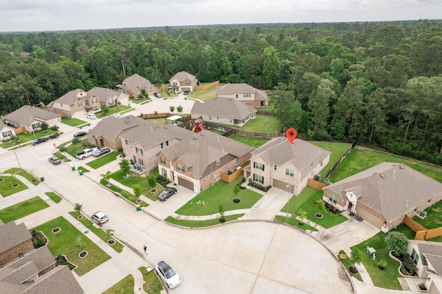 birds eye view of property with a view of trees and a residential view