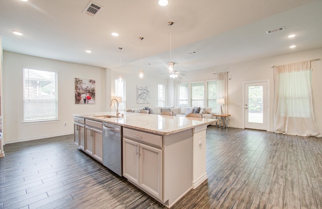 kitchen with open floor plan, visible vents, a sink, and dishwasher