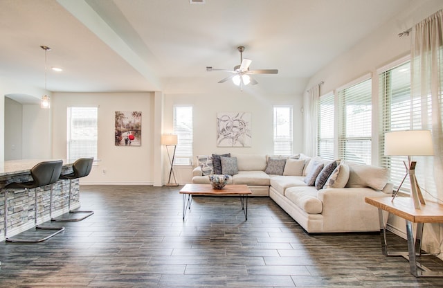 living area featuring ceiling fan, arched walkways, baseboards, dark wood-style floors, and recessed lighting