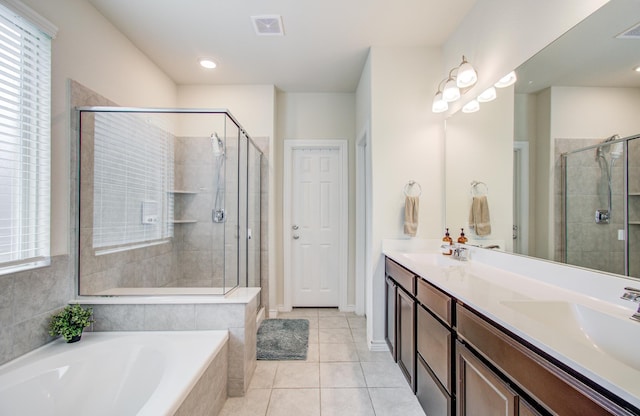 full bath featuring visible vents, a garden tub, tile patterned flooring, double vanity, and a stall shower