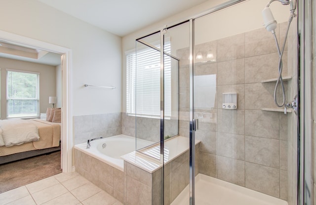 ensuite bathroom featuring tile patterned flooring, a stall shower, and a bath