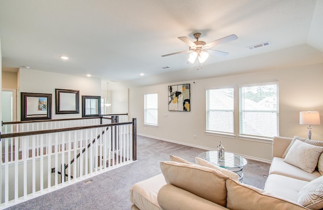 living area with a ceiling fan, visible vents, baseboards, carpet, and recessed lighting