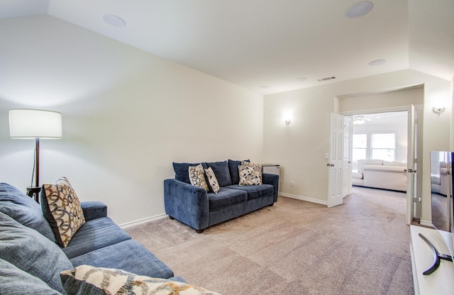 living area featuring visible vents, baseboards, light colored carpet, and lofted ceiling