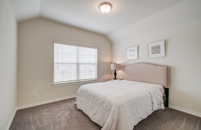 carpeted bedroom with baseboards and lofted ceiling