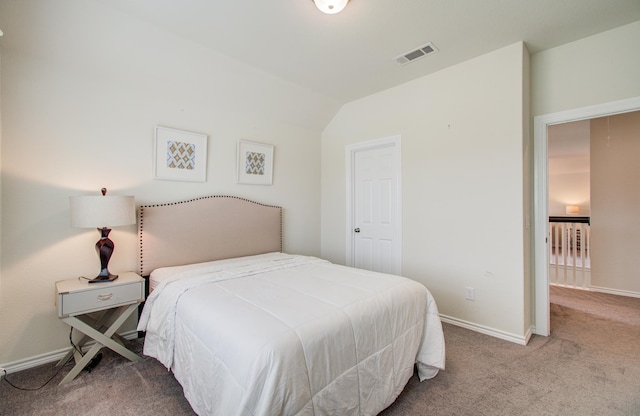 bedroom with visible vents, carpet, baseboards, and vaulted ceiling
