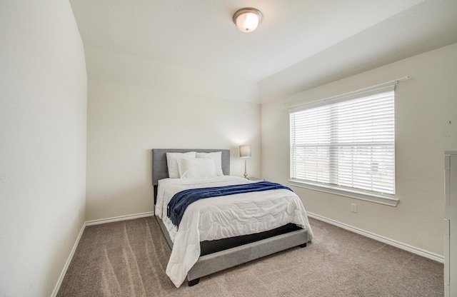 carpeted bedroom featuring baseboards