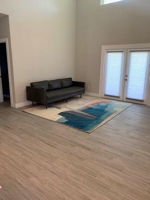 1019 E 37th St, Houston, TX 77022 - living area with baseboards, french doors, and light wood finished floors