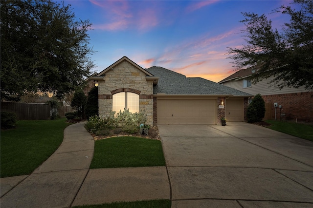 28406 Green Mill Ct, Spring, TX 77386 - french country inspired facade with a front yard, a garage, fence, concrete driveway, and stone siding