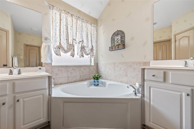 28406 Green Mill Ct, Spring, TX 77386 - bathroom with a garden tub, visible vents, vaulted ceiling, and vanity