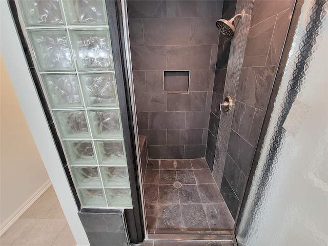 5703 Fraser Ave, Galveston, TX 77551 - bathroom with baseboards, tile patterned flooring, and a stall shower