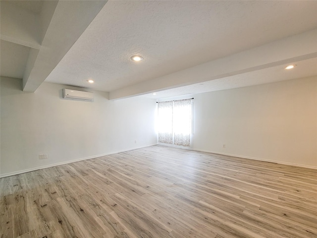 5703 Fraser Ave, Galveston, TX 77551 - empty room featuring light wood-style floors, baseboards, recessed lighting, a textured ceiling, and a wall mounted AC