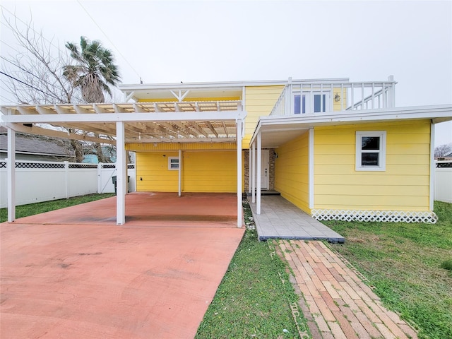 5703 Fraser Ave, Galveston, TX 77551 - back of house featuring fence and a carport