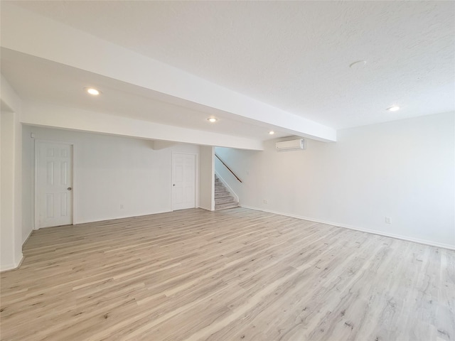 5703 Fraser Ave, Galveston, TX 77551 - finished basement featuring light wood-style flooring, recessed lighting, baseboards, a wall mounted AC, and stairway