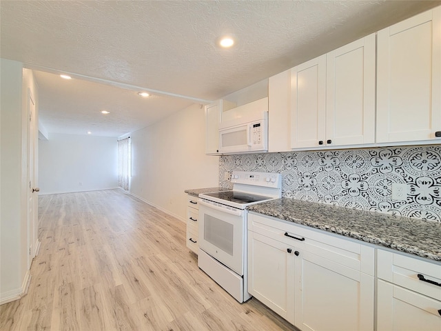 5703 Fraser Ave, Galveston, TX 77551 - kitchen with tasteful backsplash, baseboards, white cabinets, light wood-style floors, and white appliances