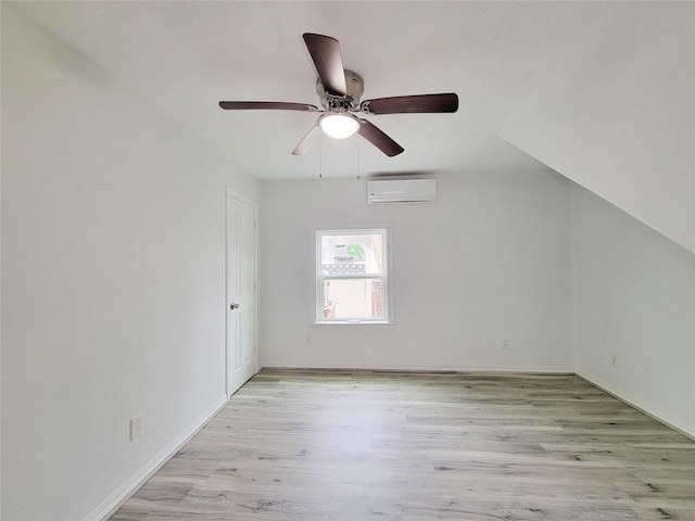 5703 Fraser Ave, Galveston, TX 77551 - interior space featuring baseboards, ceiling fan, an AC wall unit, and light wood-type flooring