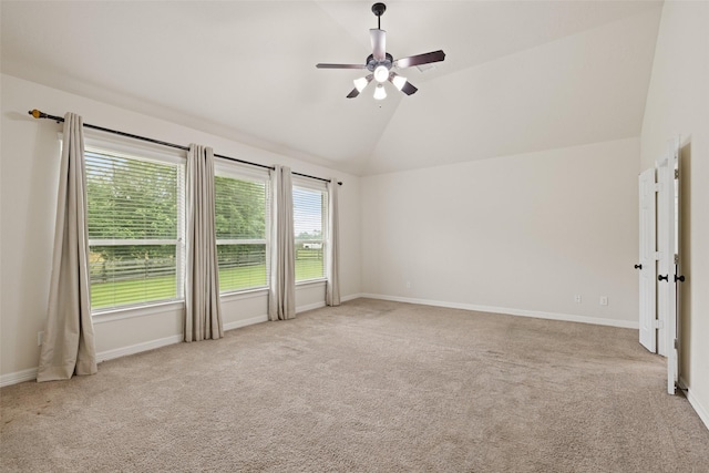 carpeted spare room featuring ceiling fan, baseboards, and lofted ceiling