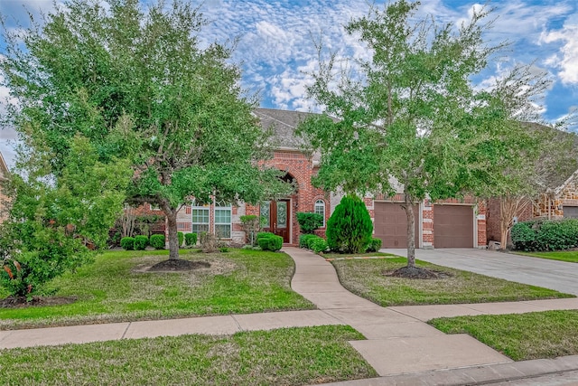 view of front of property with concrete driveway, brick siding, and a front lawn
