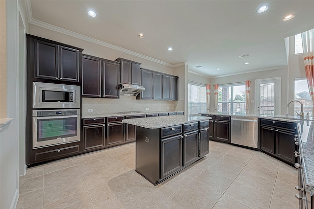 kitchen with light tile patterned floors, backsplash, stainless steel appliances, and recessed lighting