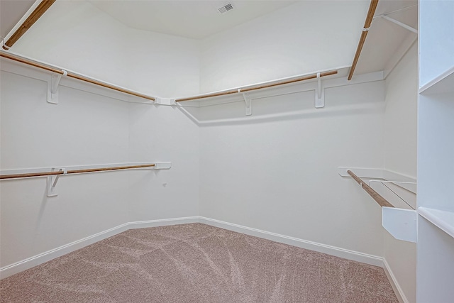 spacious closet with visible vents and carpet