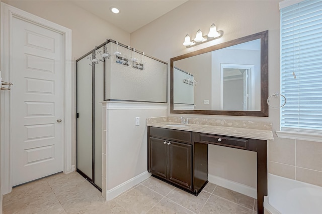 full bath featuring vanity, tile patterned floors, and a bath