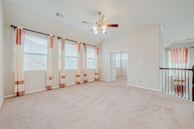 unfurnished room featuring carpet floors, ceiling fan, visible vents, and baseboards