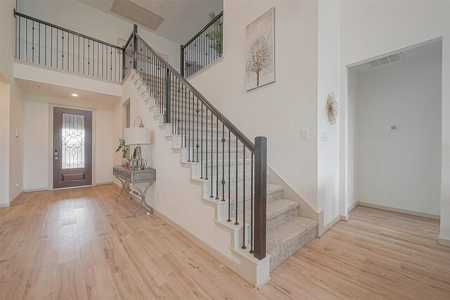 29407 Red Rocks Park Dr, Katy, TX 77494 - foyer entrance with a high ceiling, stairs, wood finished floors, and visible vents
