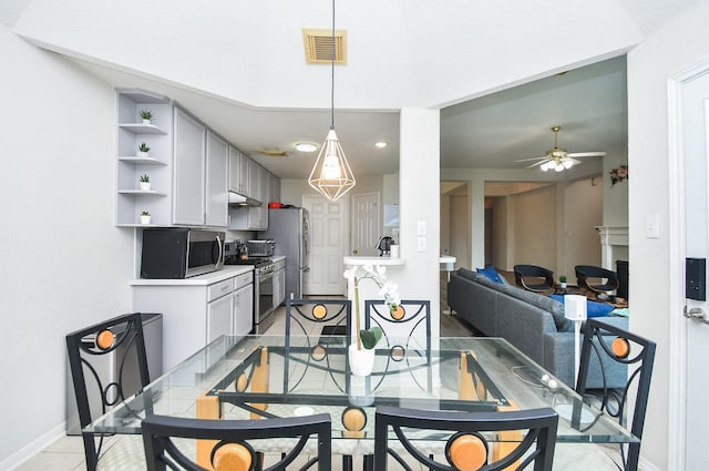 dining room with a ceiling fan, baseboards, and visible vents